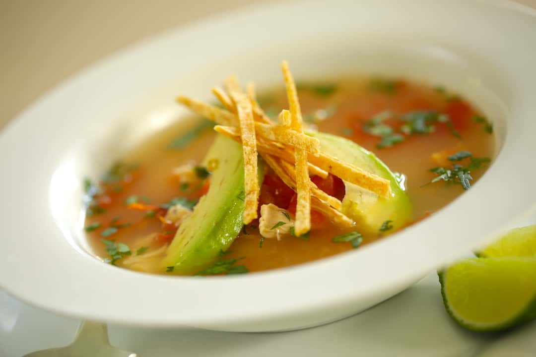 Easy Tortilla Soup in a bowl topped with garnishes