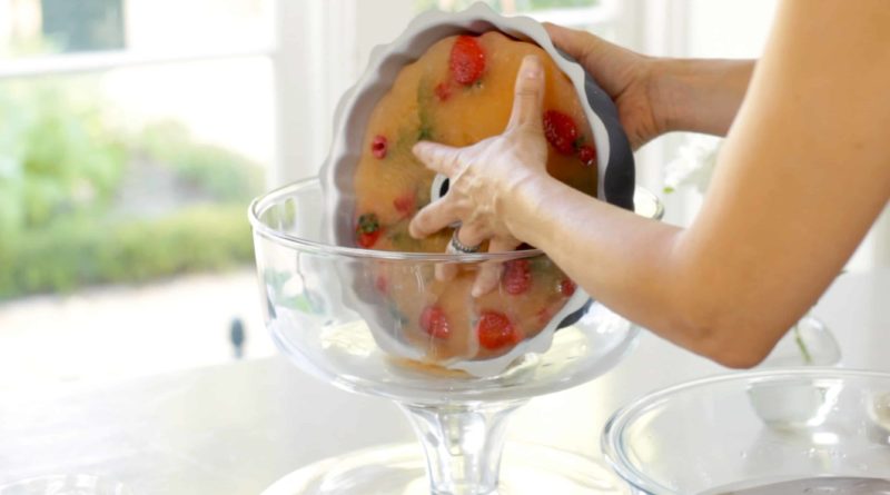 Removing an ice block of punch from a bundt pan into a punch bowl 