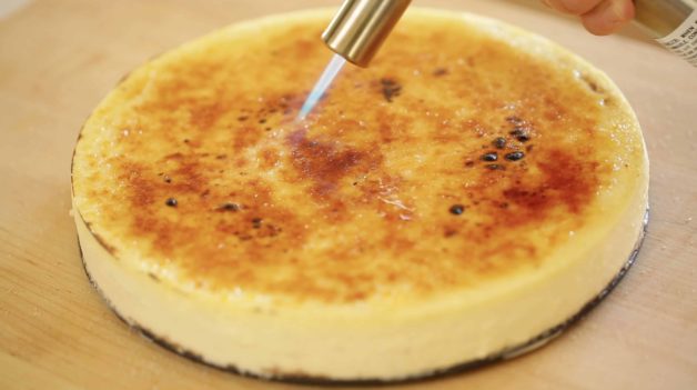 Creme Brulee Cheesecake Recipe being bruled with a kitchen torch