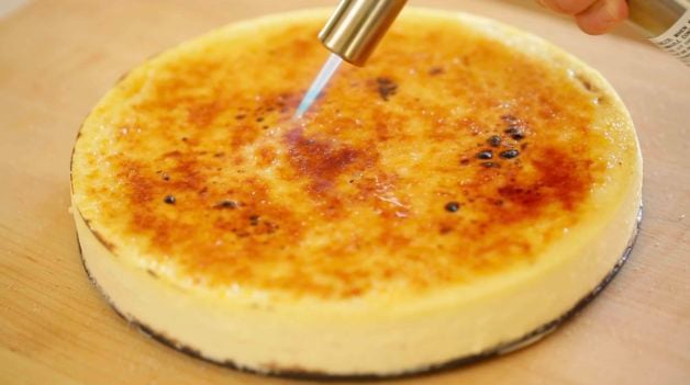 Creme Brulee Cheesecake Recipe being bruled with a kitchen torch