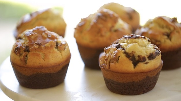 Banana Nut Muffins with black bottoms on cake stand