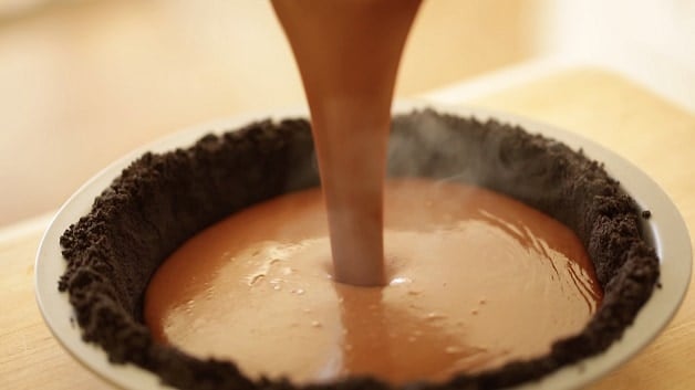 Pouring chocolate filling into pie crust