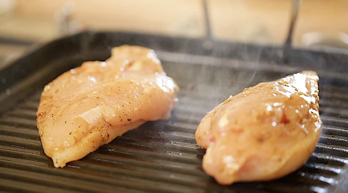 Chicken breasts grilling on a grill pan 
