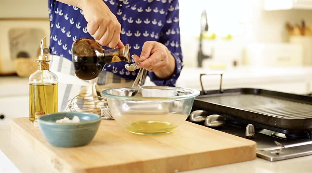 a person mixing up a chicken marinade