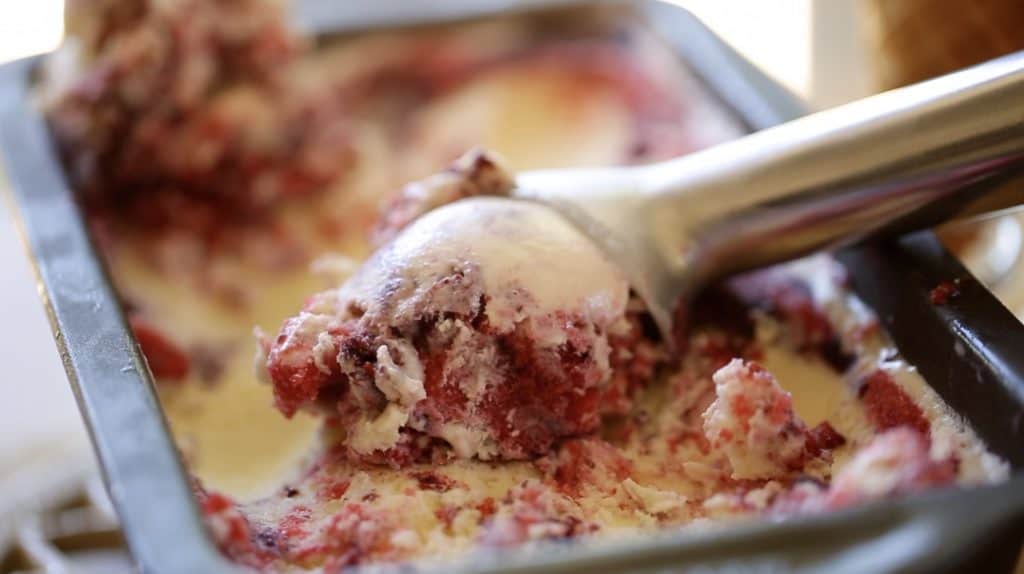 Red, White and Blue Ice Cream in a tin with an ice cream scoop scooping a serving