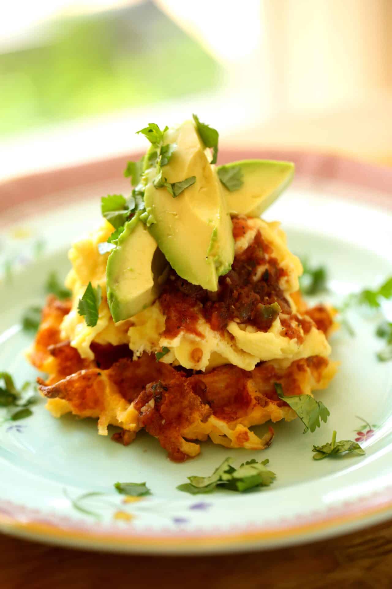 Crispy Hash brown Waffle with Mexican Scramble, Avocado and Salsa on top