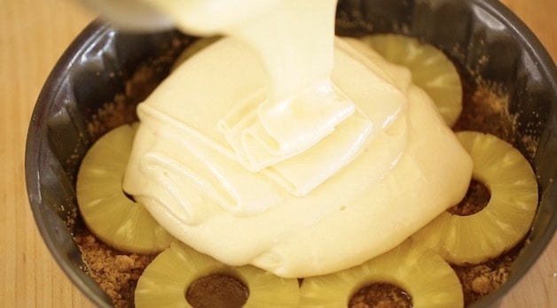 Pouring Batter onto Pineapple Rings for a Pineapple Upside Down Cake