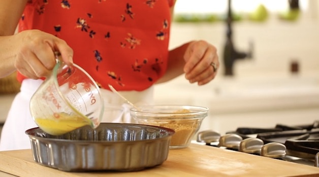 Pouring Melted Butter into a cake pan