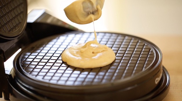 pouring batter into a waffle cone maker