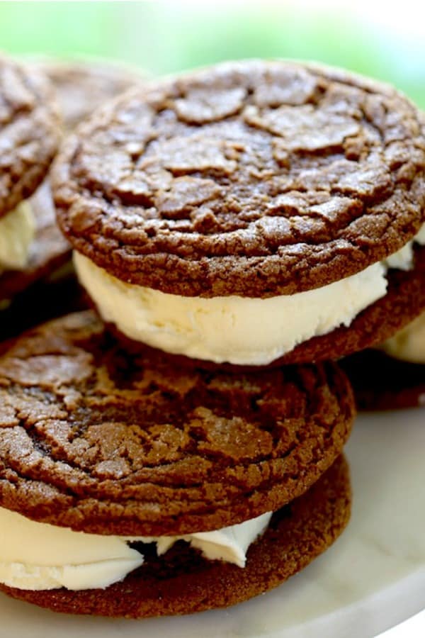A pile of Ginger Molasses Cookie sandwiches on a plate