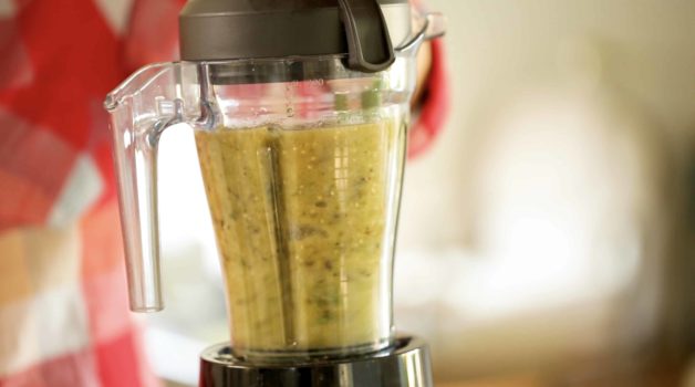 Blending peppers, tomatillos, and other ingredients in a blender for Enchilada sauce 
