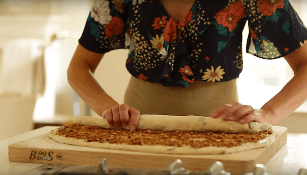 cinnamon rolls being rolled for a How to Make Cinnamon Rolls Recipe