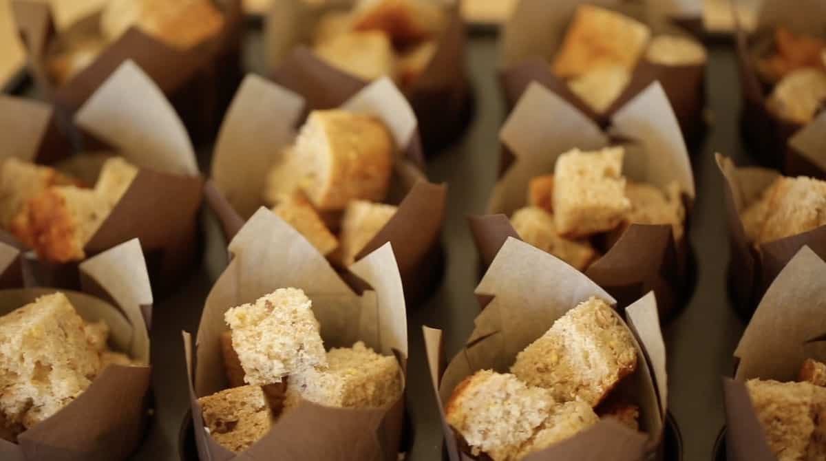 Muffin papers filled with bread cubes