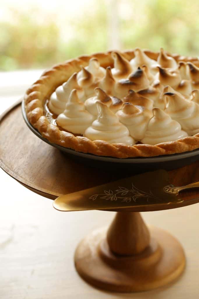 Pumpkin Pie with Marshmallow Topping on a cake stand