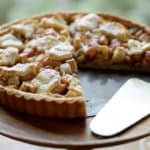 Apple Pie with Raisins and Walnuts with a slice taken out of it