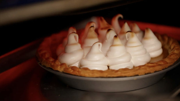 Toasting marshmallow topping on a pie in an oven 