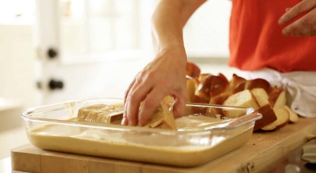 Soaking bread for a Gingerbread French Toast with Cinnamon Syrup casserole