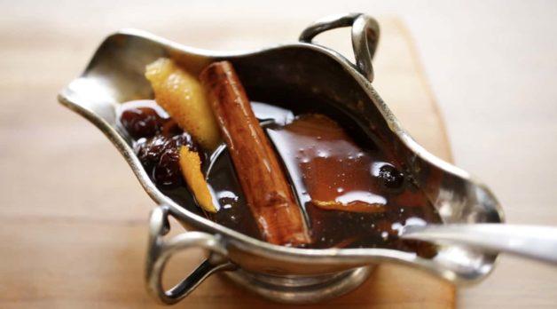 Cinnamon Syrup in a gravy boat for a Gingerbread French Toast Casserole