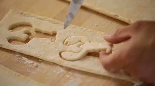 Cutting out Lobster Shapes with a knife into puff pastry for a Bouchée à la Reine with Lobster Recipe