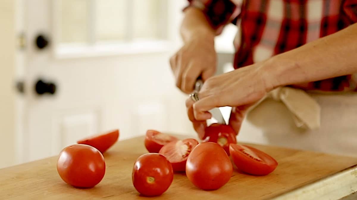 slicing a roma tomato in half