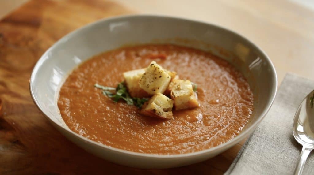 Close up shot of Tomato soup in bowl with Croutons