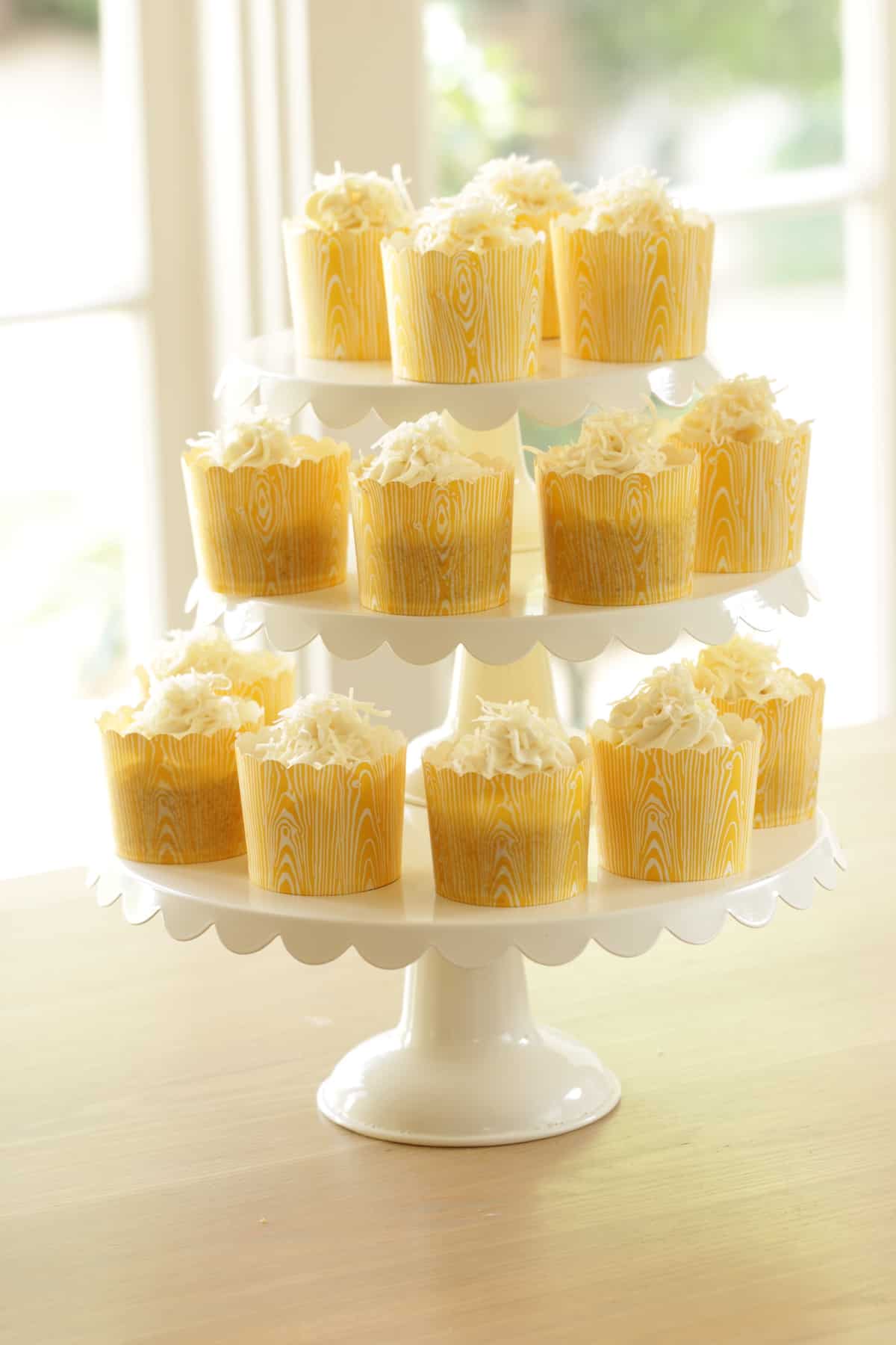 Cupcakes on a 3-tired cake stand on a table