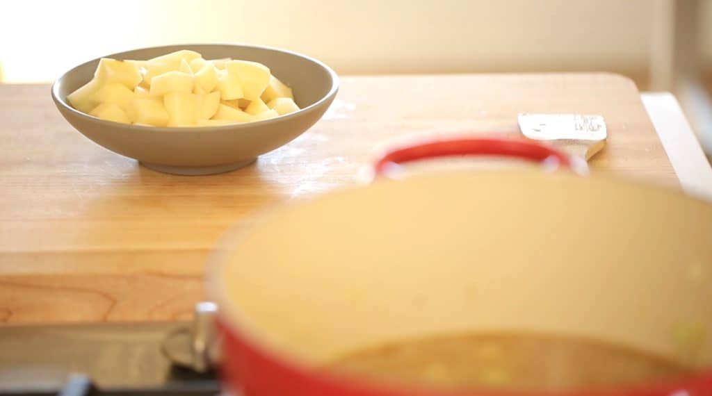 Potatoes diced in a bowl heading for a pot for a Potato Cheddar Bacon Soup Recipe