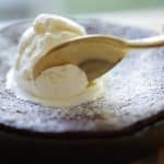 Warm Chocolate Skillet Cake in Cast-Iron Skillet with Scoop of Vanilla Ice Cream