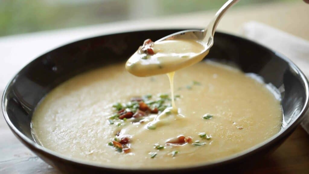 A spoon tasting a Potato Cheddar Bacon Soup Recipe