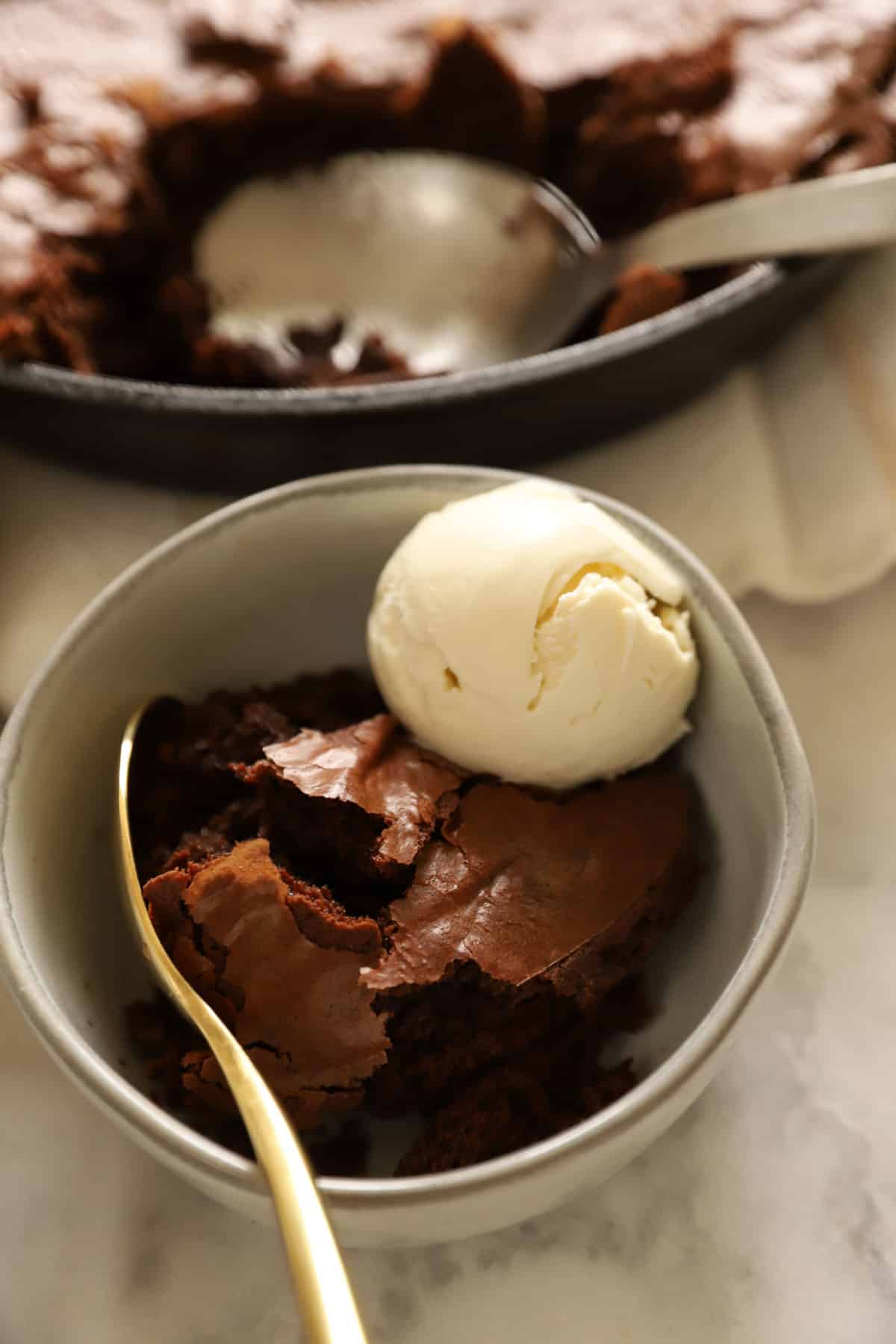 a bowl with chocolate cake and ice cream served in it
