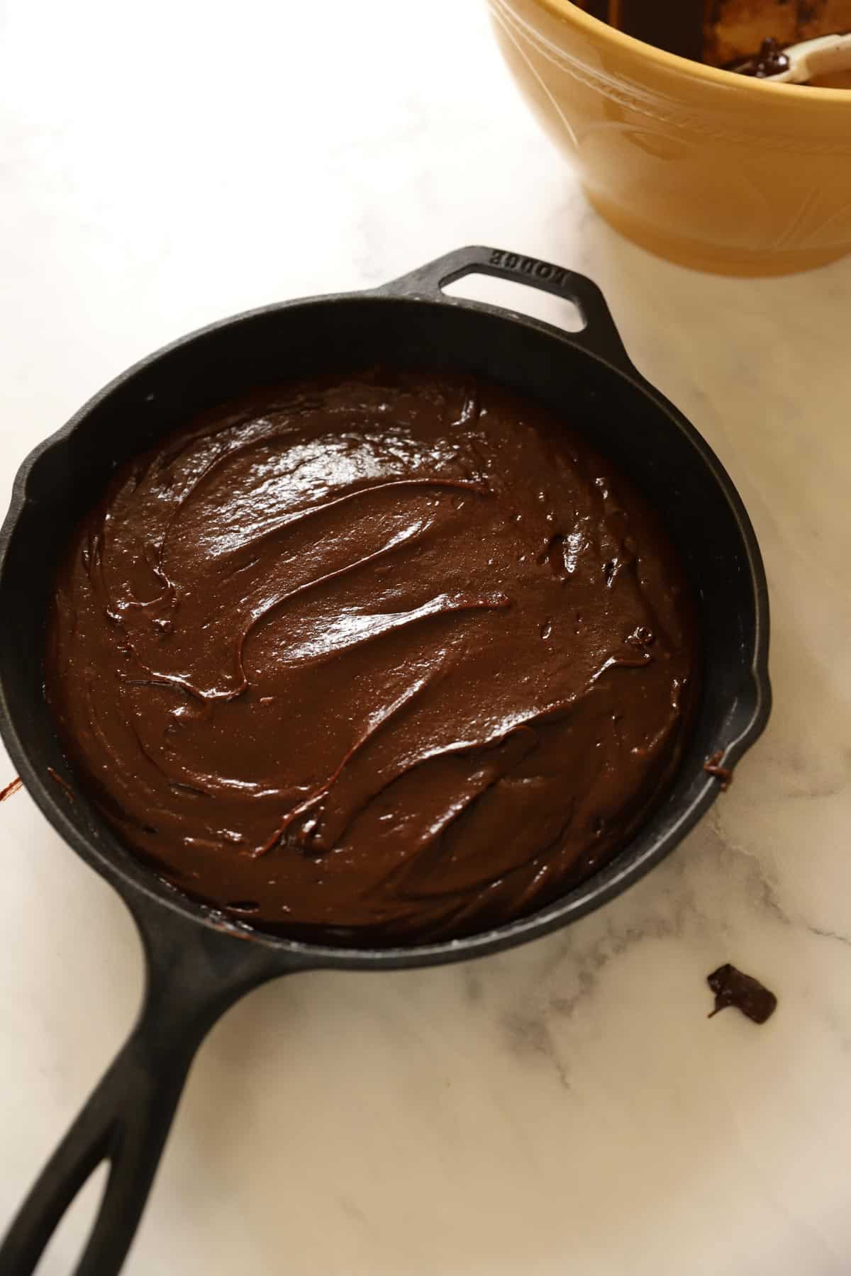Brownie batter in a cast-iron skillet