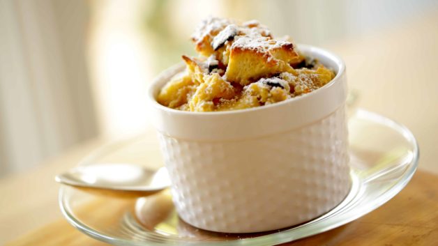 Single serving of a mini Banana Bread Pufdding served in a white ramekin