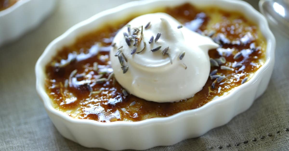 Honey Lavender Creme Brulee in ramekin with whipped cream dolloped on to