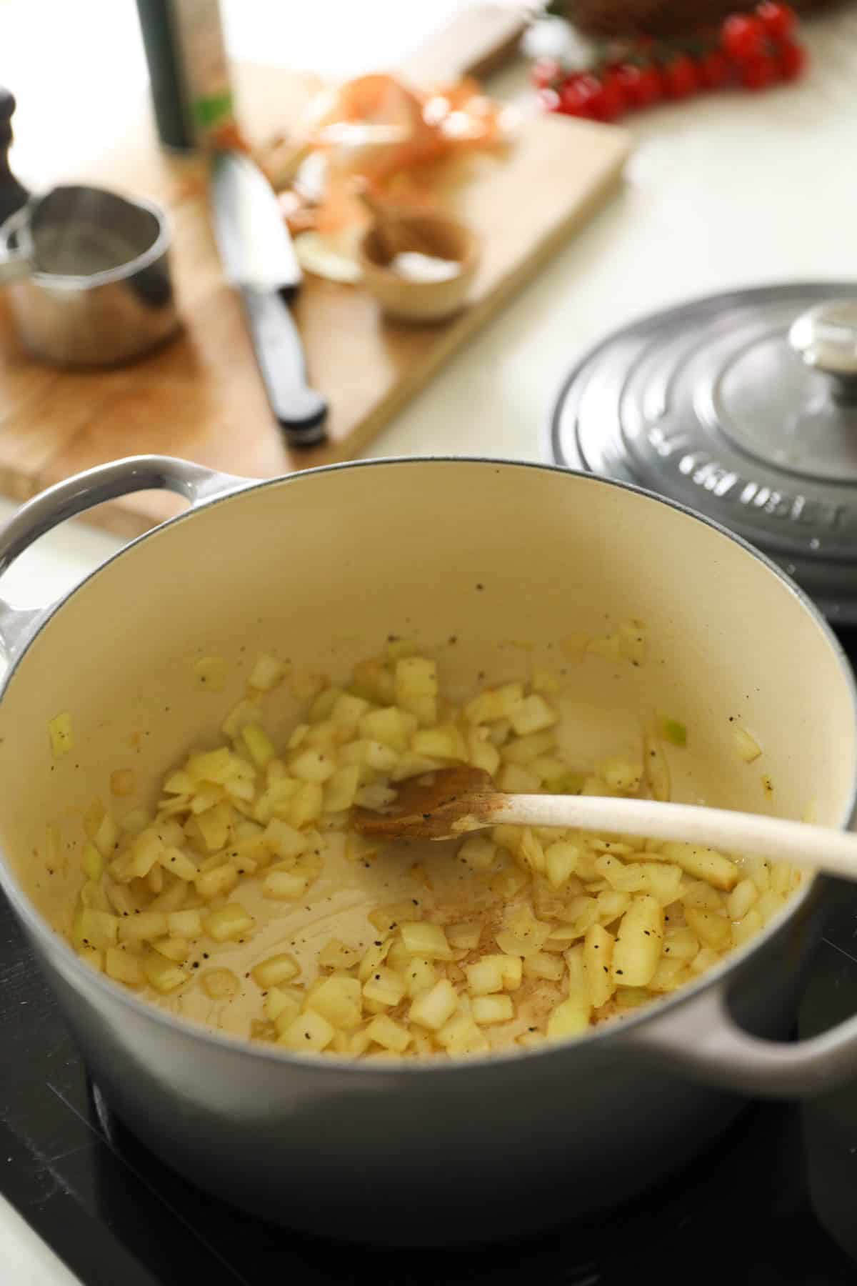 onions being sautรฉed in a dutch oven until translucent.
