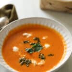 Pepper and tomato soup in a white bowl