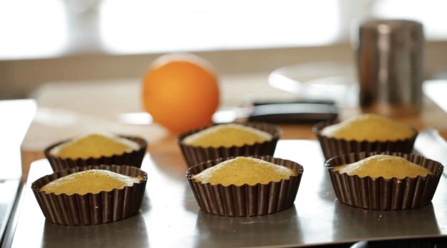 Pistachio Olive Oil Cakes in Mini Tart Tins fresh out of the oven on baking sheet