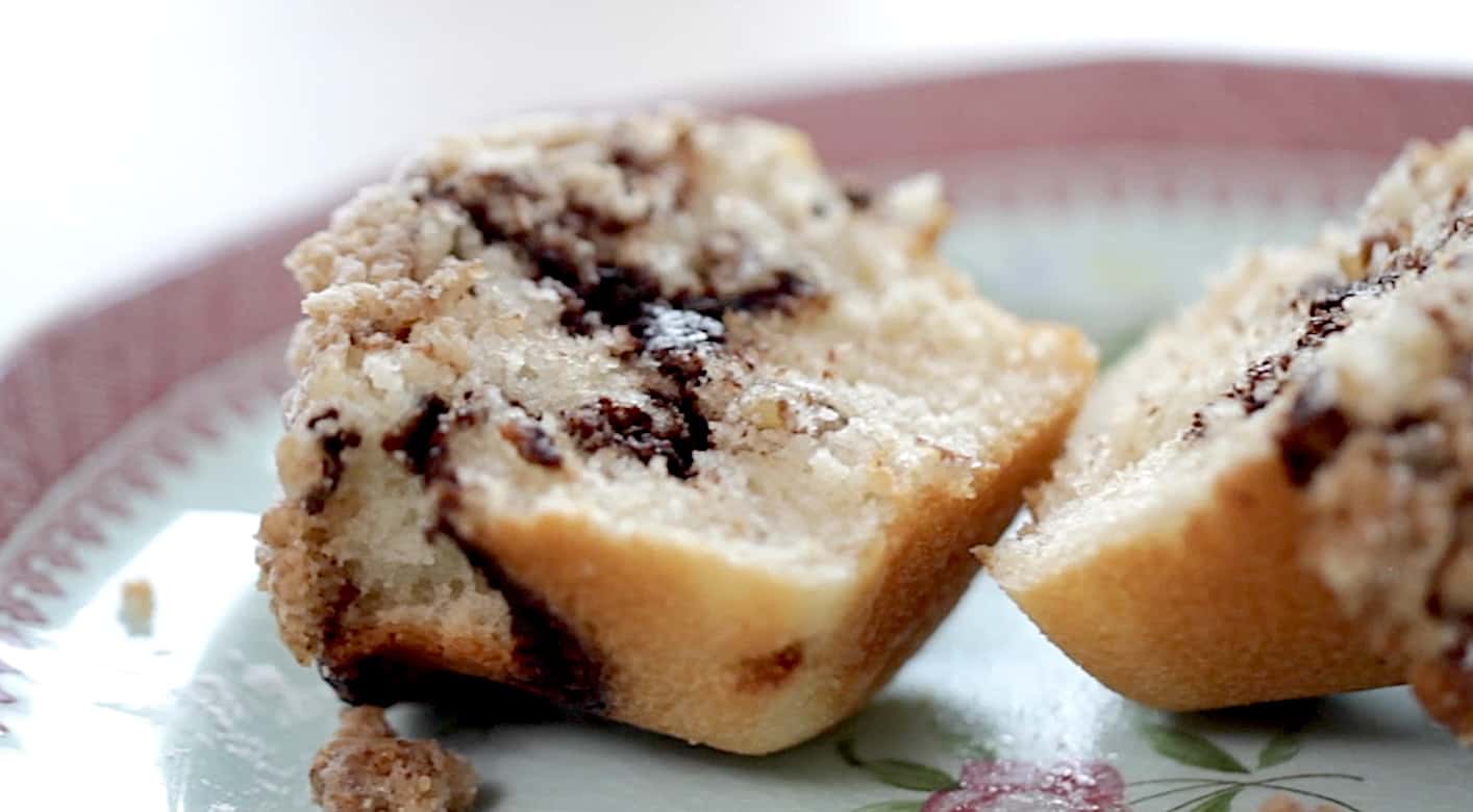 a sliced open coffee cake muffin showing the interior coffee and chocolate swirl