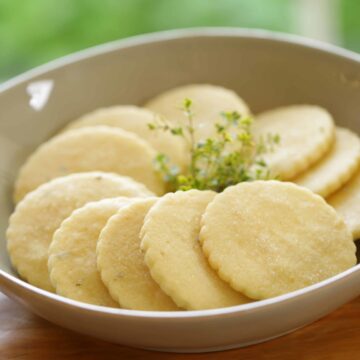 Lemon Thyme Sugar Cookies in a bowl with a sprig of Thyme