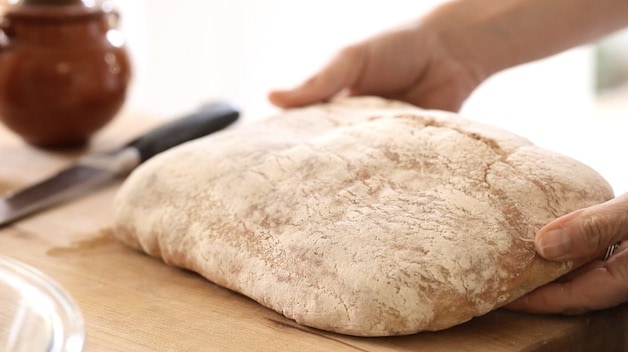 of loaf of ciabatta bread on a cutting board
