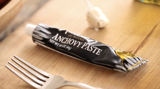a tube of Anchovy Paste on a cutting board