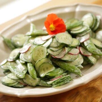 Cucumber Salad on a white Platter with Nasturtium