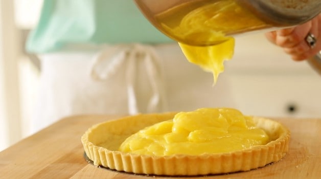 adding lemon curd into a tart crust