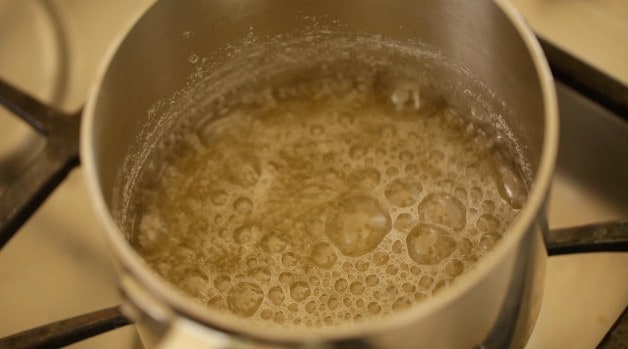 Sugar and water boiling in a sauce pot