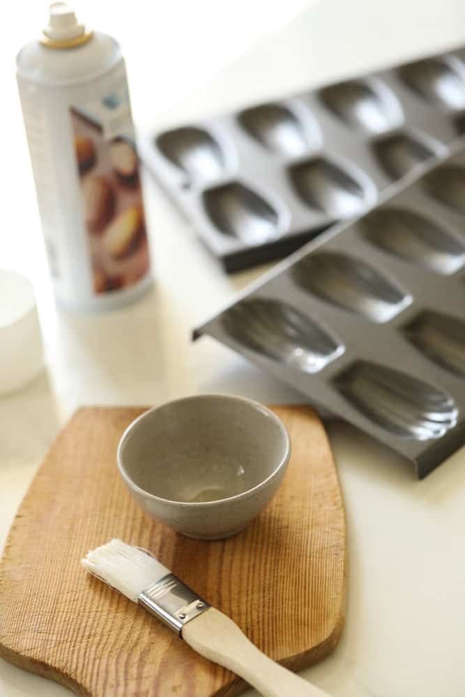 Greasing madeleines pans with baking spray