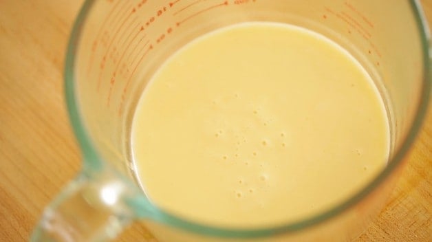 Buerre blanc sauce strained in a Pyrex Pitcher