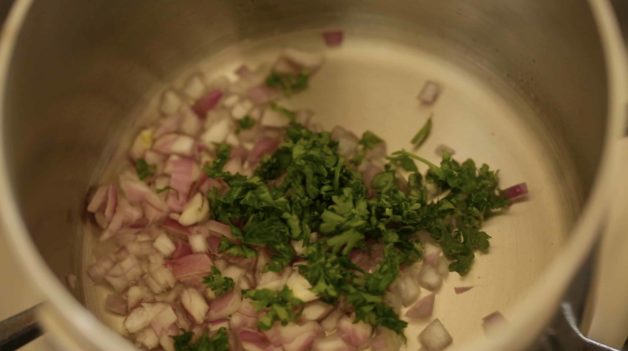 white wine, shallots, and herbs in a sauce pot