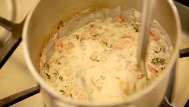 Adding cream in a pot for the start of a Beurre Blanc Sauce 