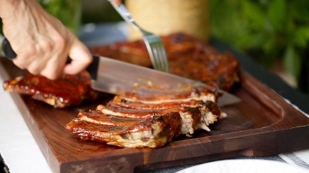 Slicing BBQ Ribs on a cutting board