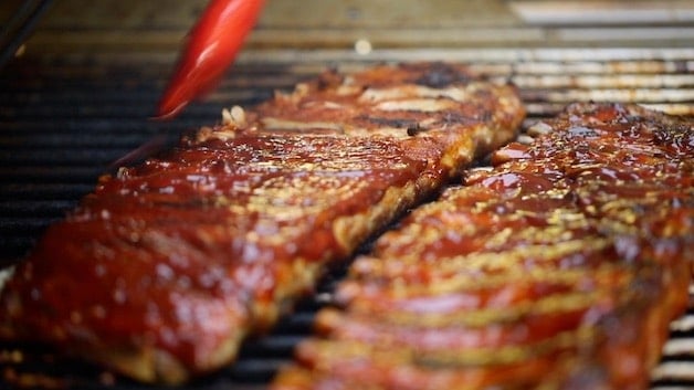 Grilling oven-baked ribs on a BBQ