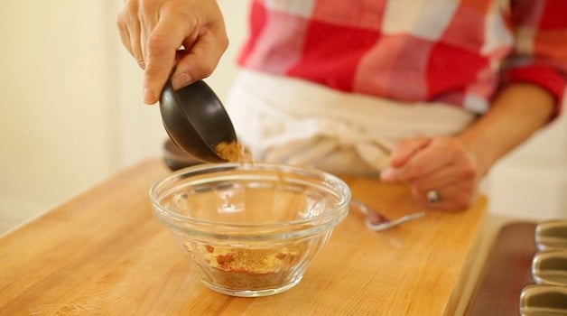 Mixing spice rubs for ribs in a small bowl